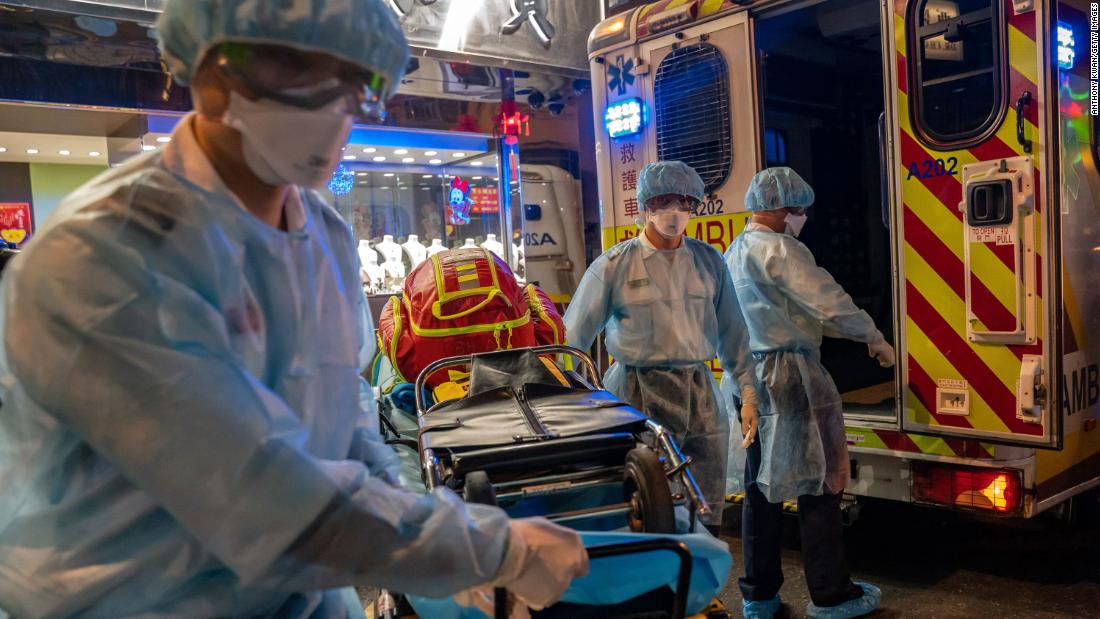 Paramedics carry a stretcher off an ambulance in Hong Kong on February 23.